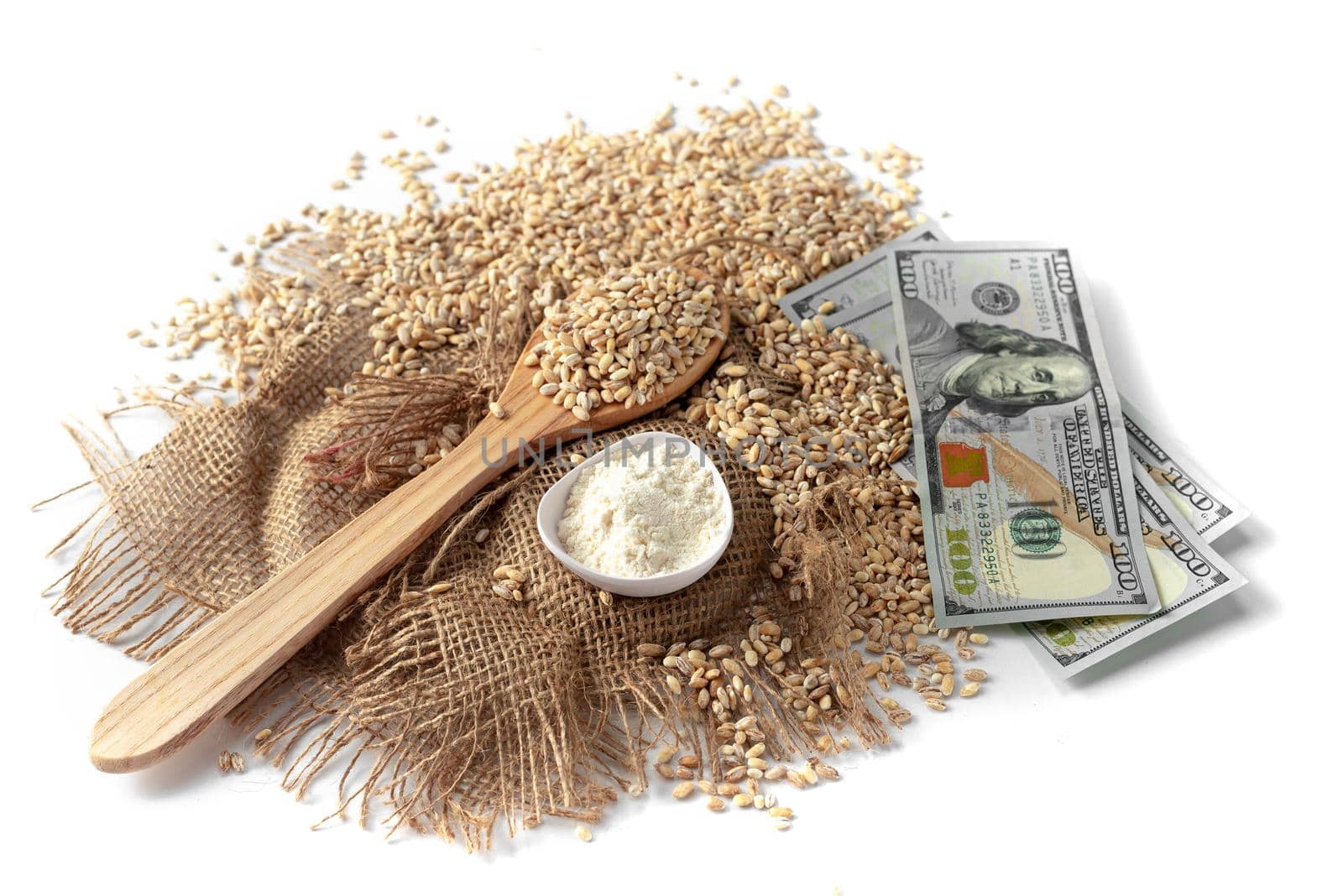 Grains of wheat or millet on a white background with money. The concept is a problem with food for grain caused by the war in Ukraine