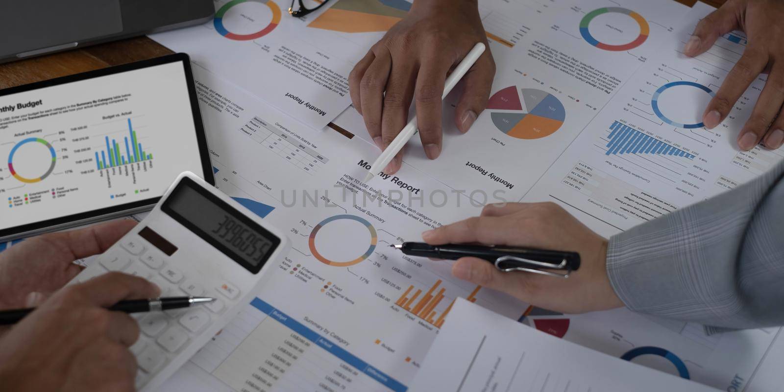 Business People Meeting using laptop computer,calculator,notebook,stock market chart paper for analysis Plans to improve quality next month. Conference Discussion Corporate Concept.