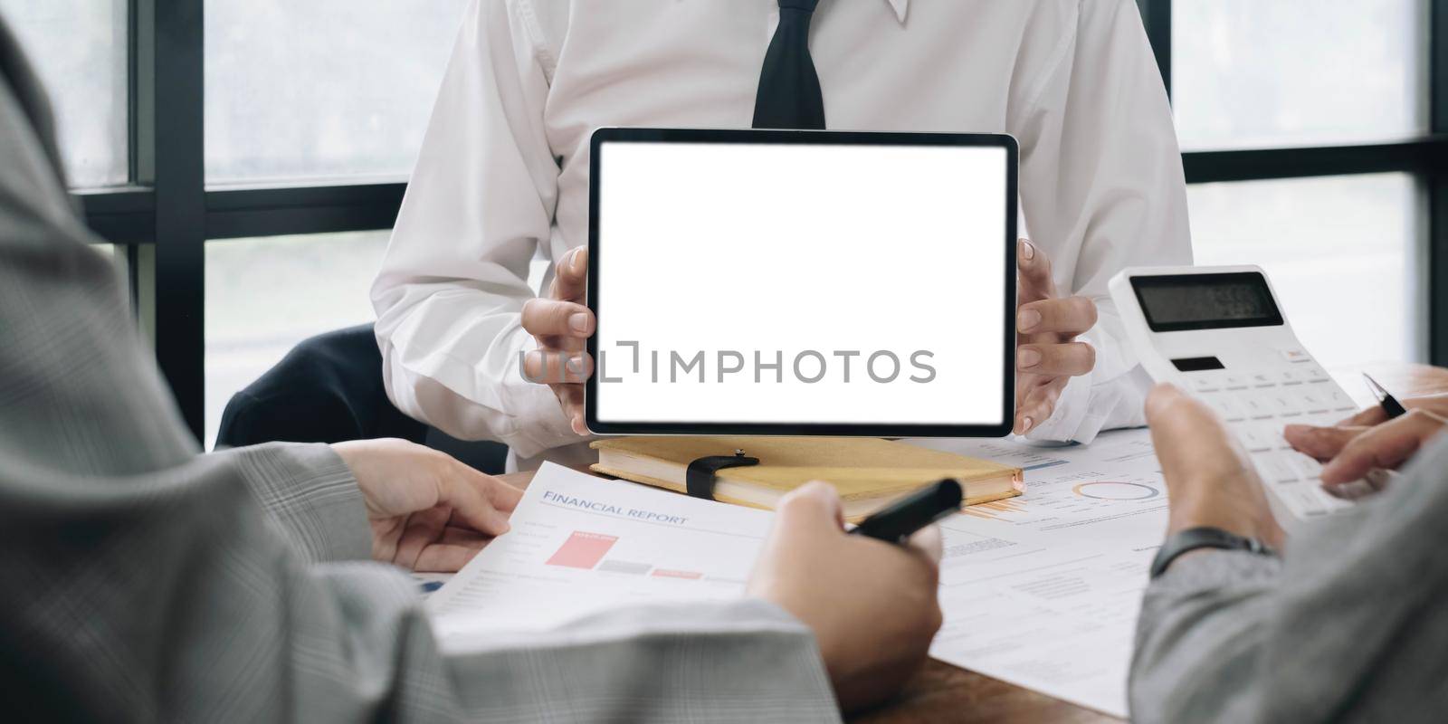 Close up of business team working analysis brainstorm together tablet blank white screen placed at office. Mock up. by wichayada