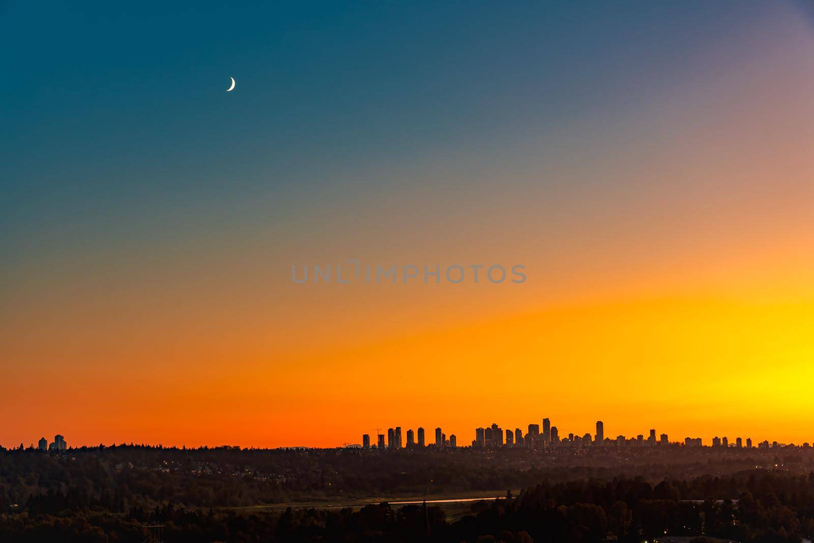 Metrotown district under the moon on sunset sky background.
