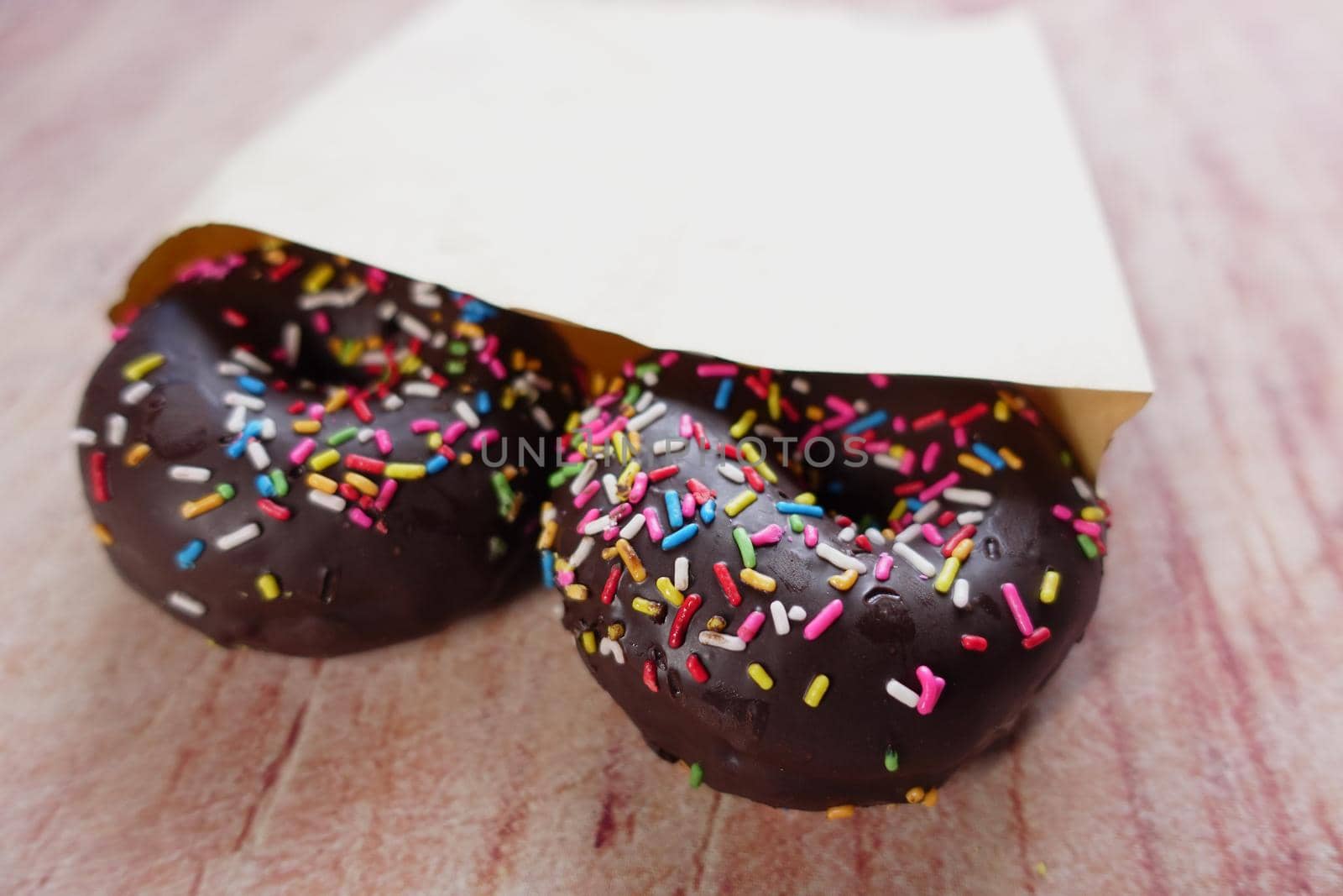 chocolate donuts on plate with copy space.