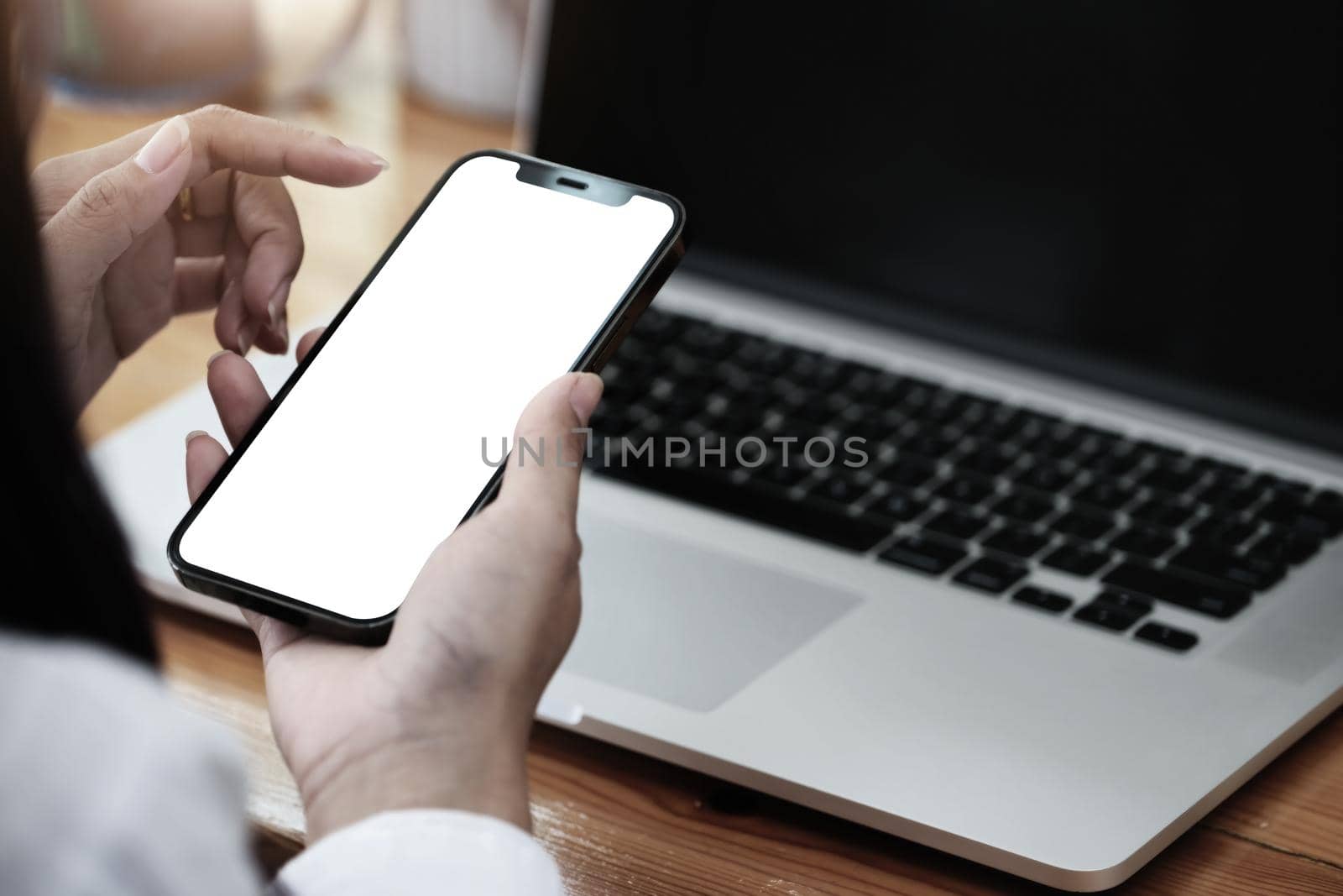 Woman hand holding smartphone Blank screen mobile phone for graphic display montage. by Manastrong