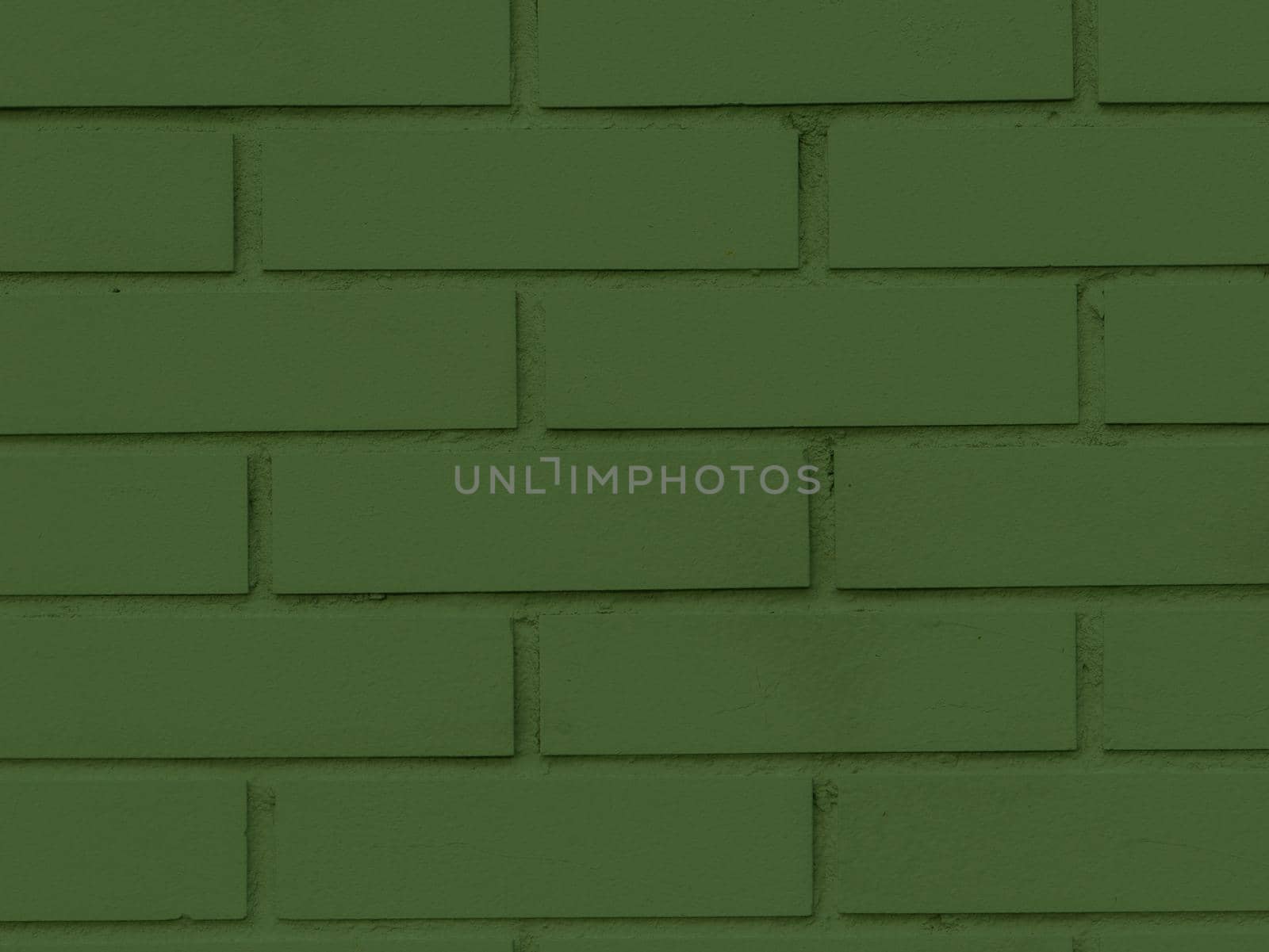 Old Green Brick Building Surface. Patinated and textured brick wall