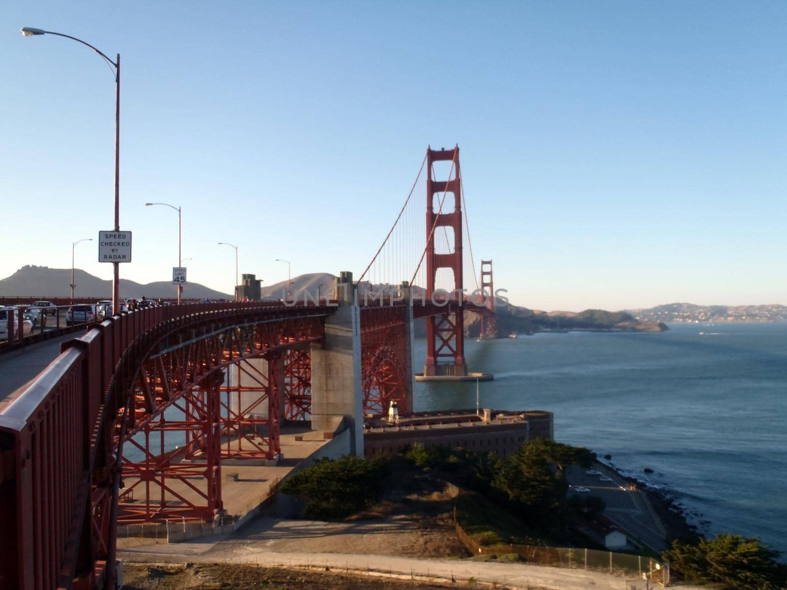 The Golden Gate Bridge in San Francisco bay seen from beginning of bridge on San Frnacisco side in California.  Old historic Fort Point can be seen below bridge.