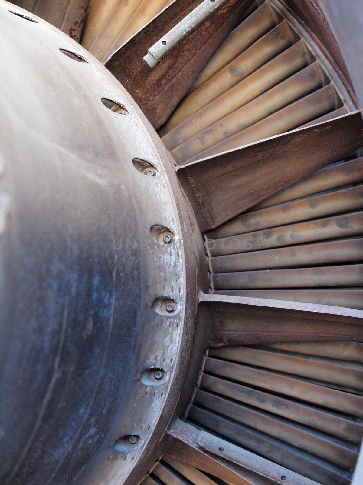 Close up of turbine and fan blades of a jet engine with signs of wear. by EricGBVD