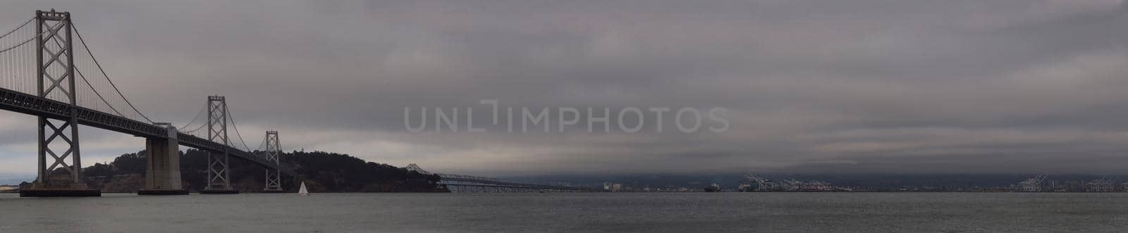 Panoramic of Boat sail by the San Francisco Bay Bridge on a foggy day by EricGBVD