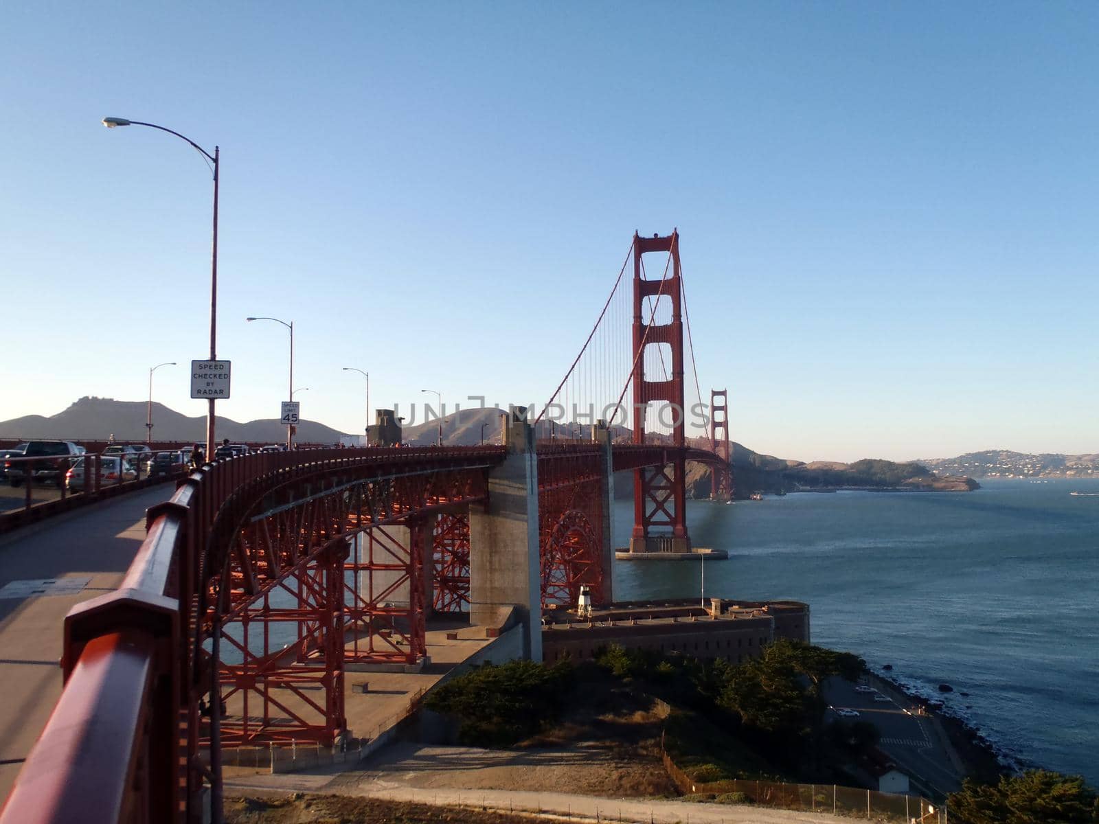 The Golden Gate Bridge in San Francisco bay seen from beginning of bridge on San Frnacisco side in California.  Old historic Fort Point can be seen below bridge.