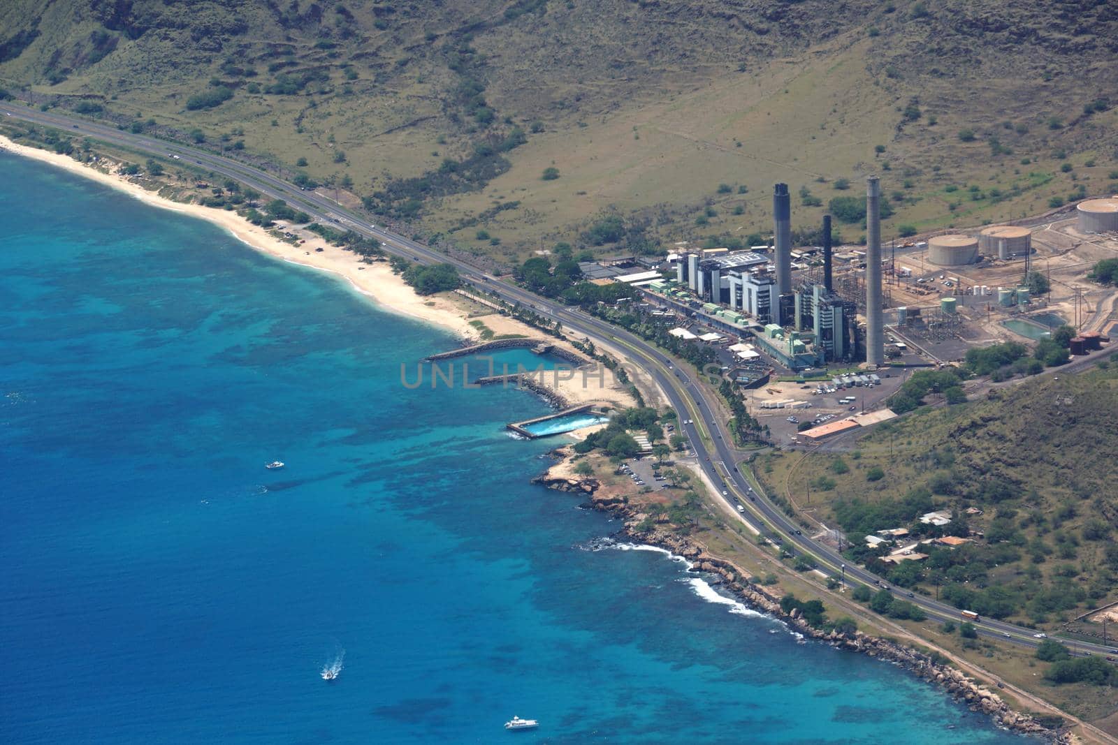 Aerial view of Kahe Point Power Plant along the ocean with highway road by EricGBVD