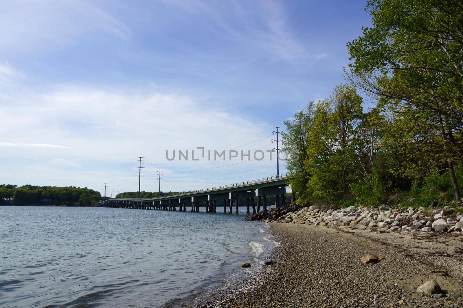 Rocky beach leading to a Bridge and Power lines by EricGBVD