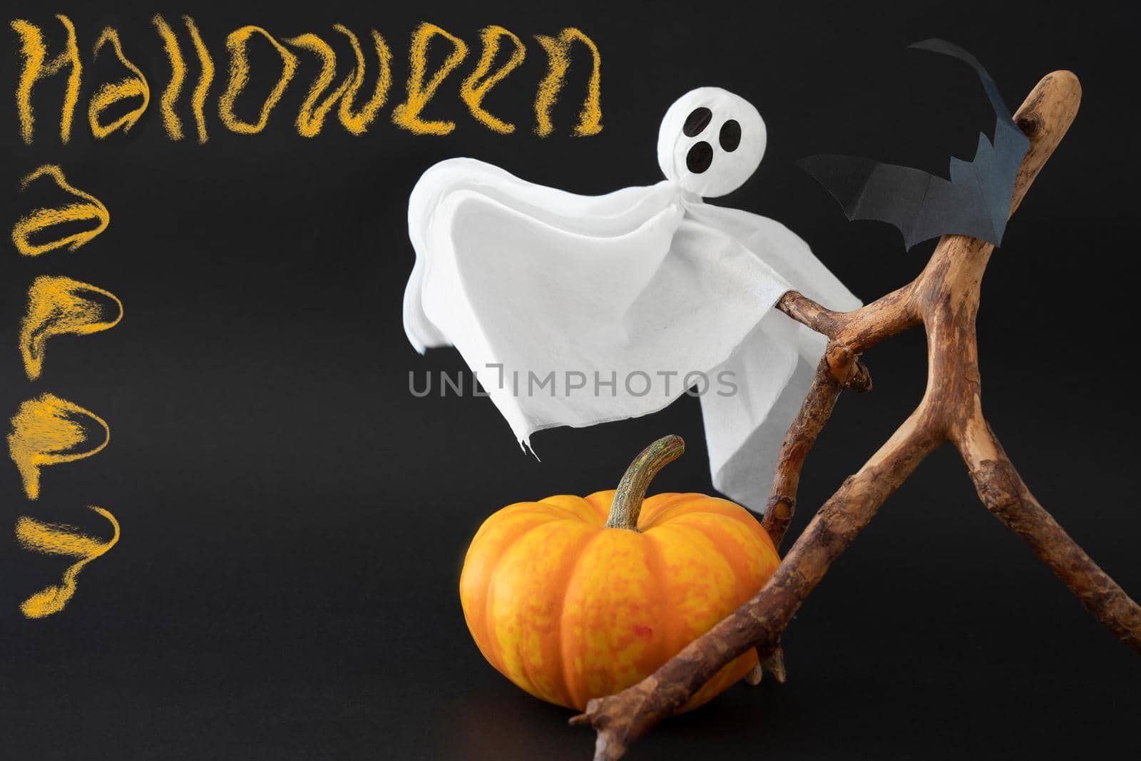 Pumpkin, ghost and bats on black background with inscription Happy Halloween. Concept of Halloween