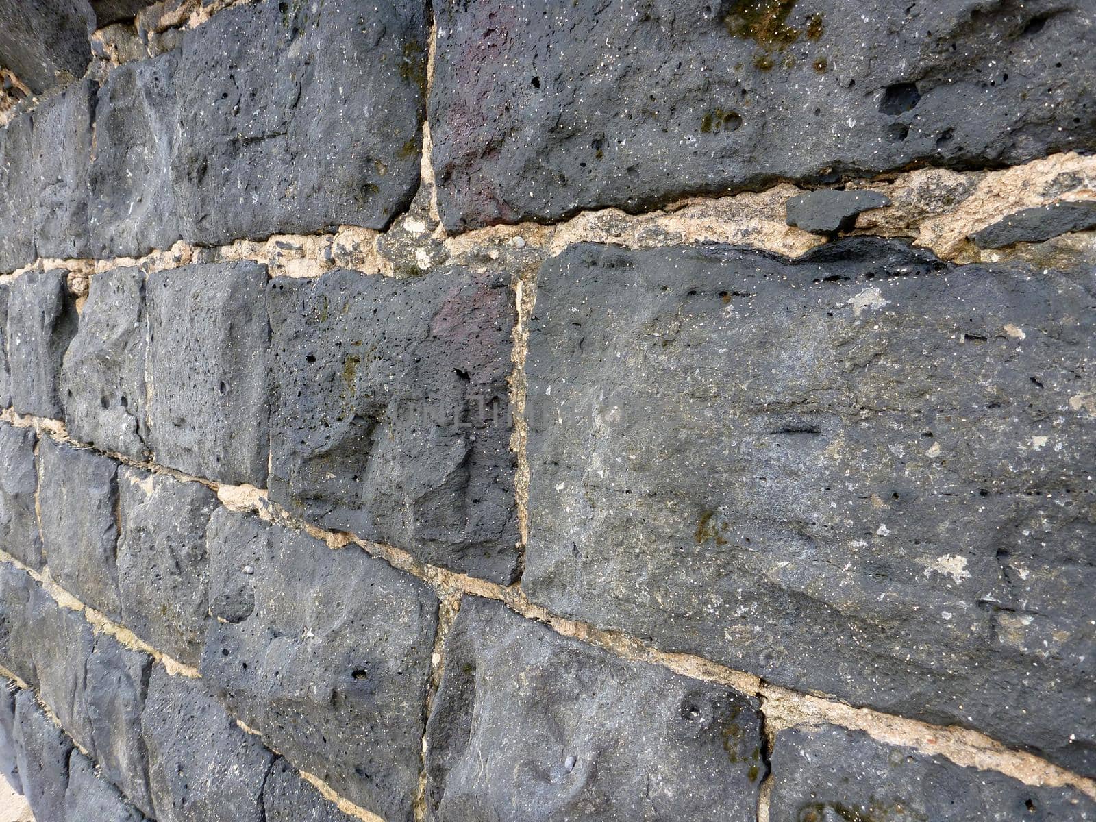 Close-up of a old Cemented lava stone wall by EricGBVD