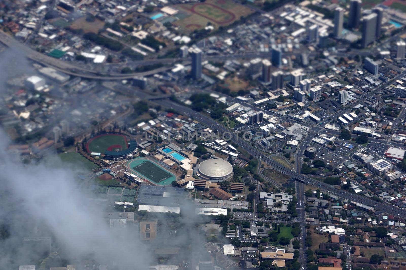 Aerial view of Landmark University of Hawaii Baseball Les Murakami Stadium and Stan Sheriff Center in Manoa with H-1 Highway and Surrounding town community Honolulu, Hawaii June 13, 2014.