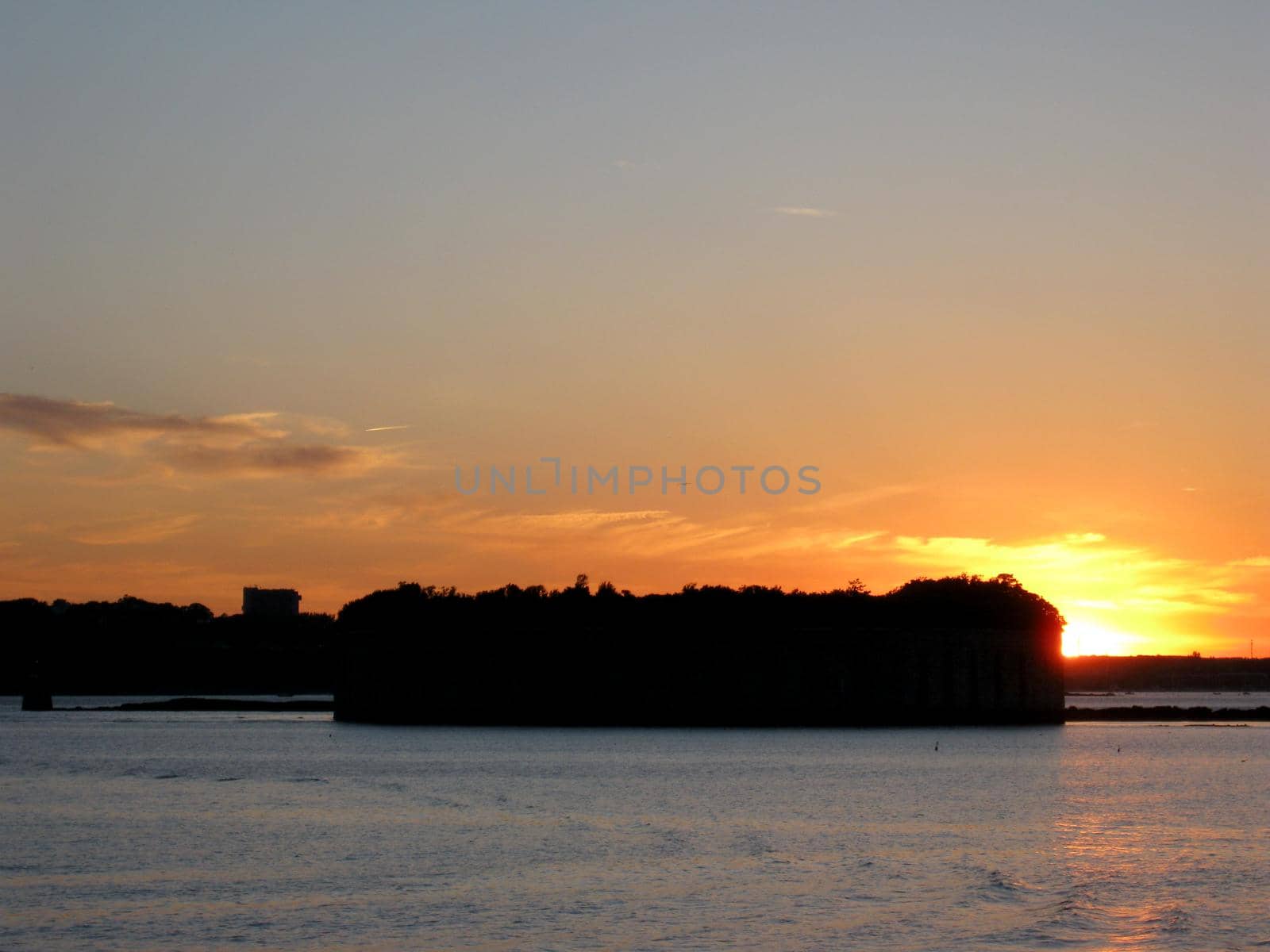 Sunset over the Fort Gorges is on Hog Island Ledge, in Casco Bay at the entrance to the harbor at Portland, Maine.