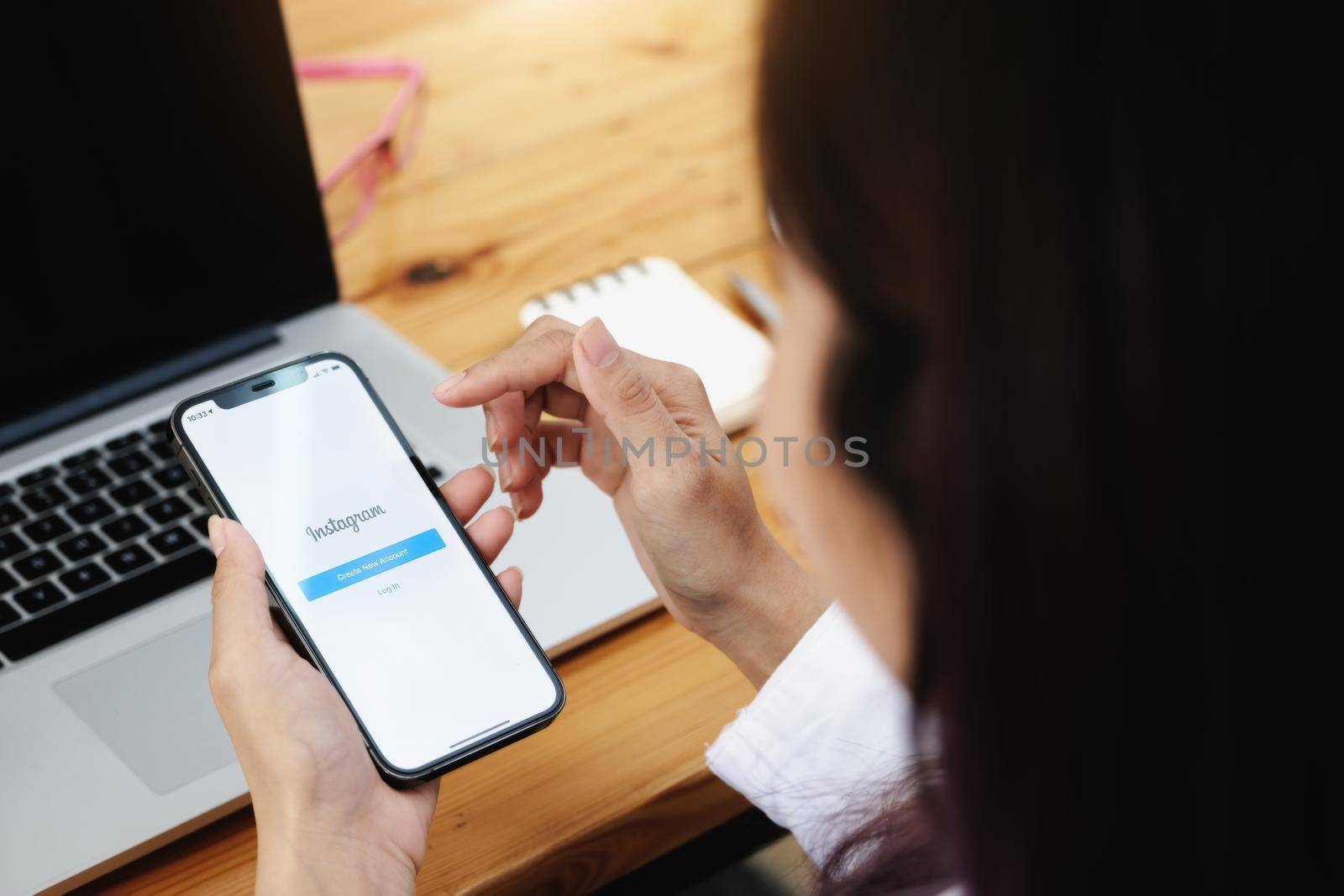 CHIANGMAI, THAILAND - MAY 30, 2021: A woman holding smartphone with Instagram application on the screen. Instagram is a photo sharing app for smartphones