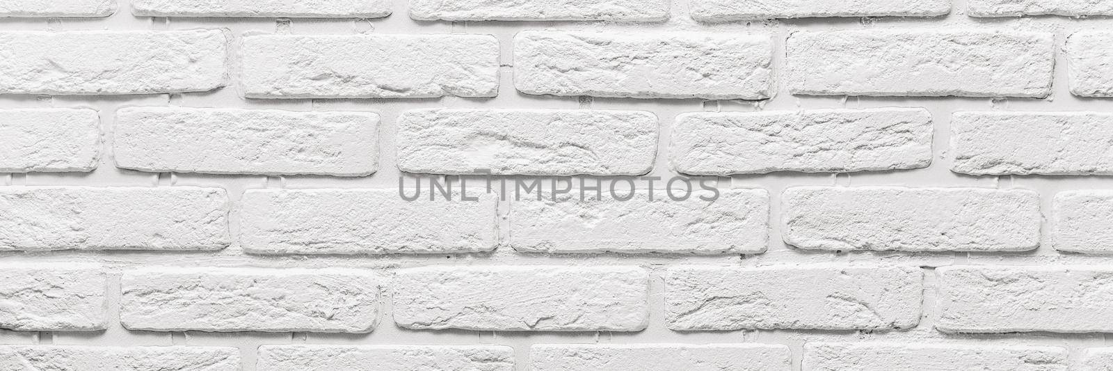 long white brick wall. The texture of the old brick painted with white paint. Web banner by etonastenka