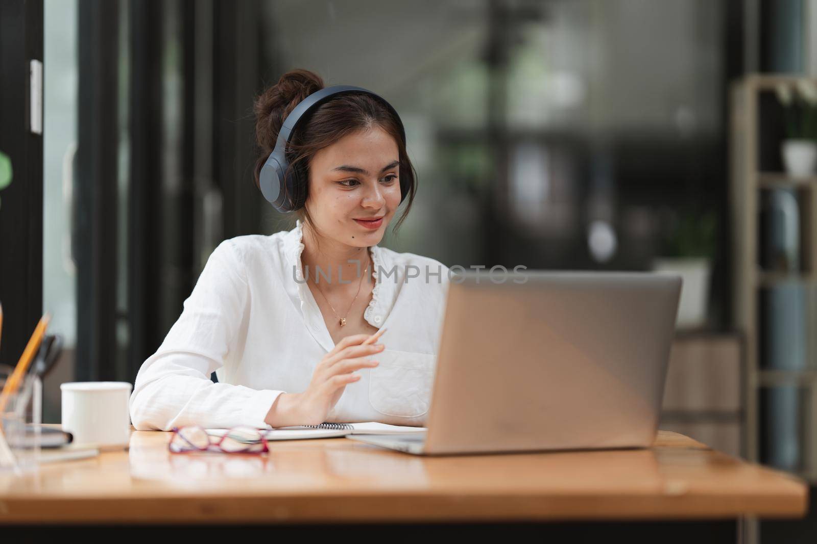 Image of Young woman working online on laptop computer. studying or working from home online concept. by itchaznong