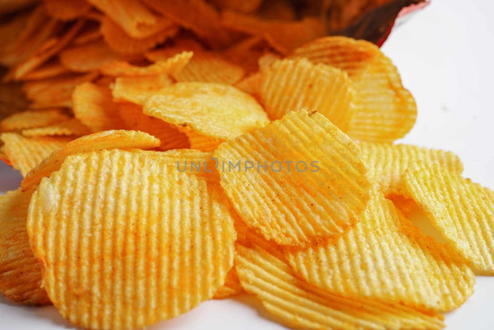 Potato chips in open bag, delicious BBQ seasoning spicy for crips, thin slice deep fried snack fast food.