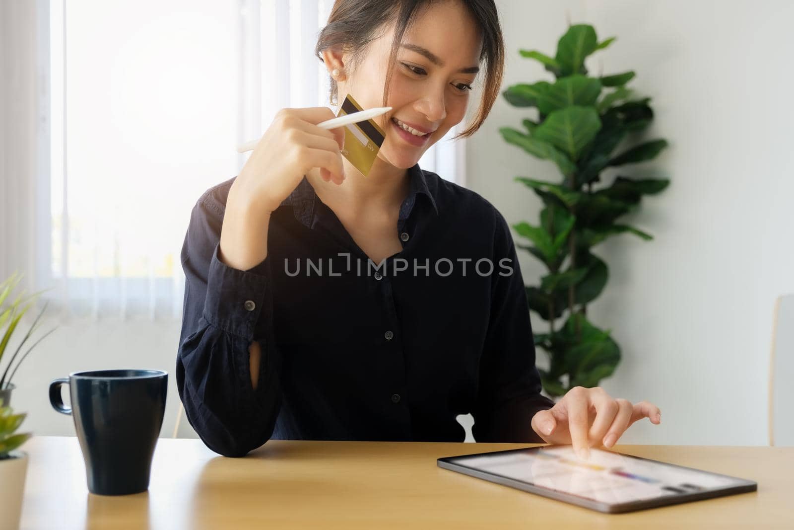 Online payment, Young Women's using tablet and hand holding cradit card for online shopping. by Manastrong