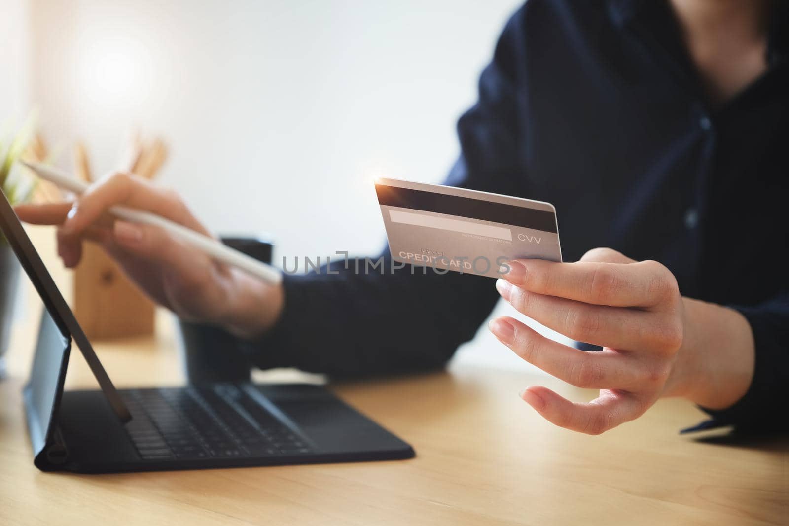 Online payment, Young Women's hands holding credit card and using tablet for online shopping. by Manastrong