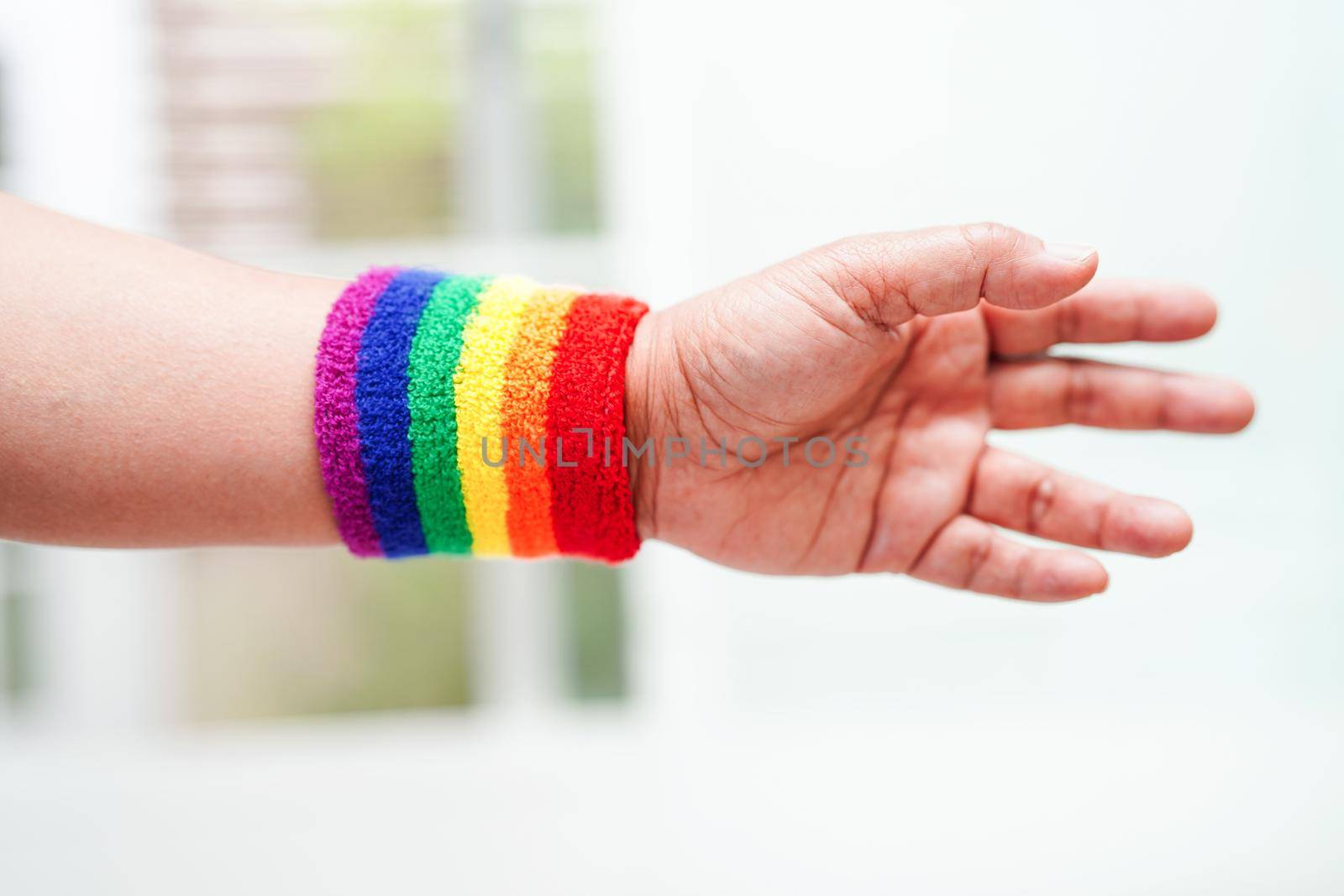 Asian woman with rainbow flag, LGBT symbol rights and gender equality, LGBT Pride Month in June.