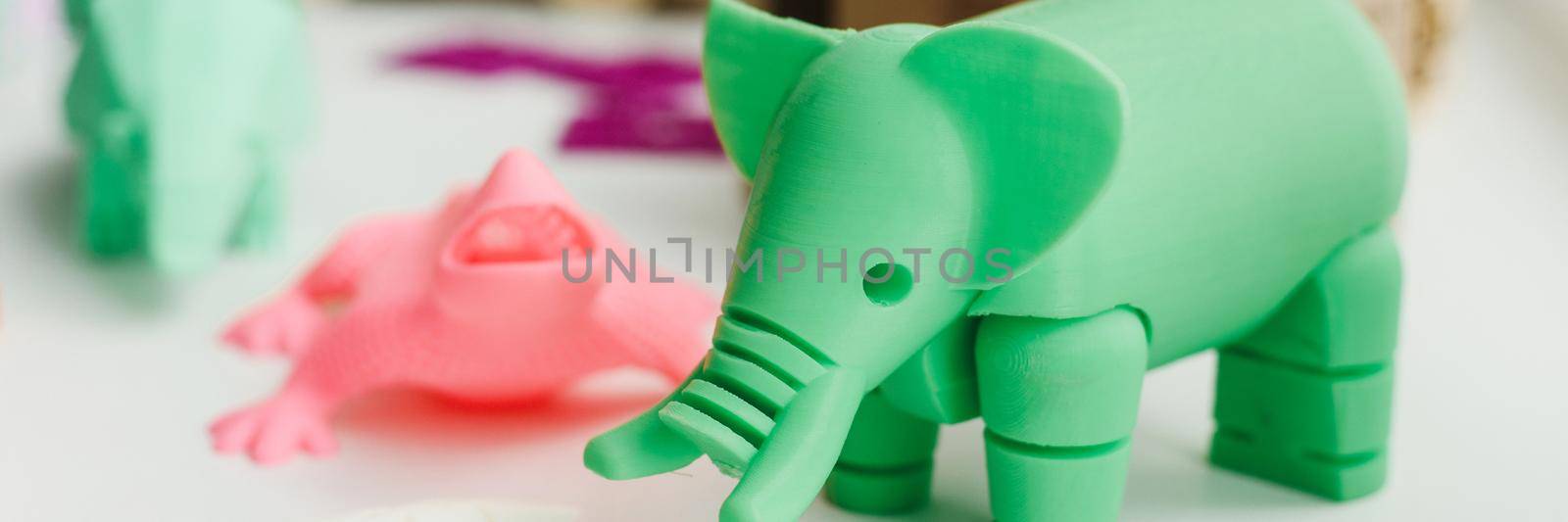 3D figures printed on an elephant, lizard, and snail printer. 3d toys for children. Web banner.