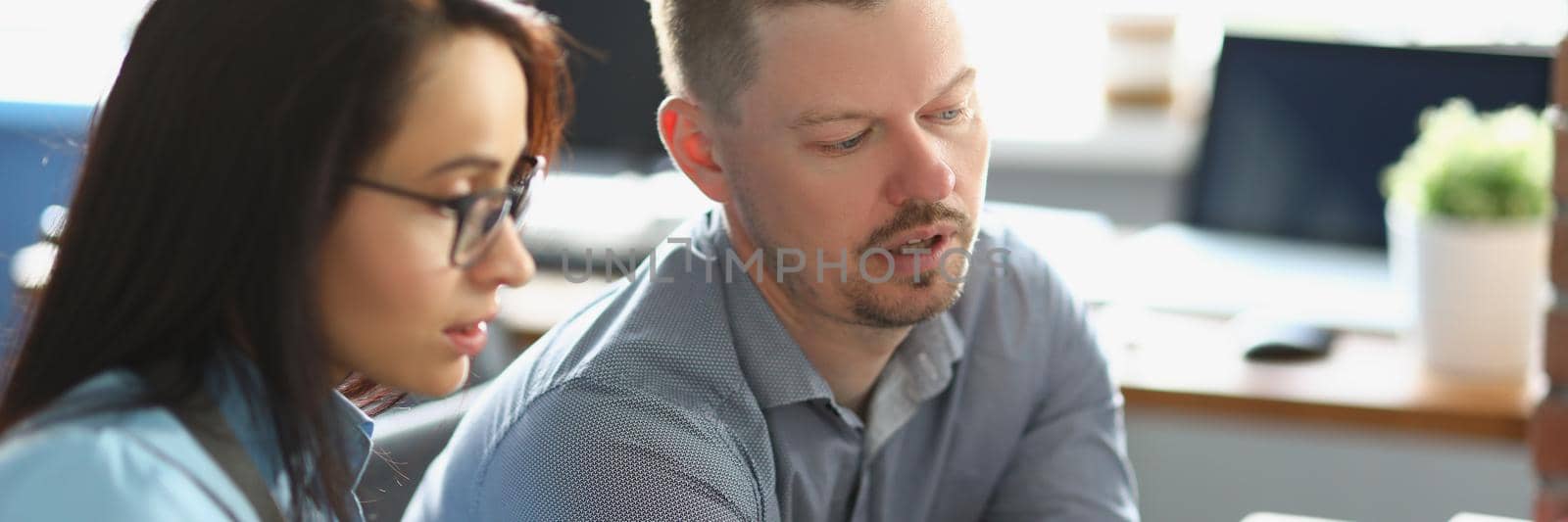 Portrait of smart man colleague help coworker with working process, explain something on laptop. Office life, corporate, business, education, learn concept