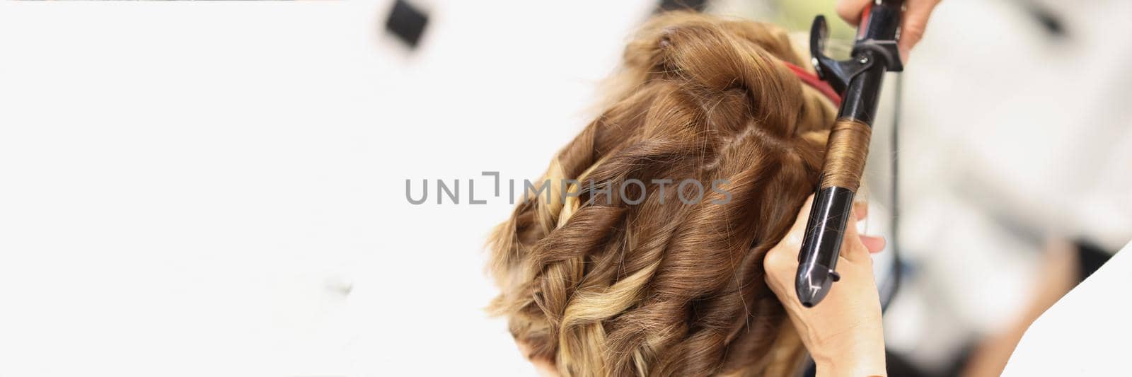 Blonde female on hairdresser appointment get curly hairstyle by kuprevich