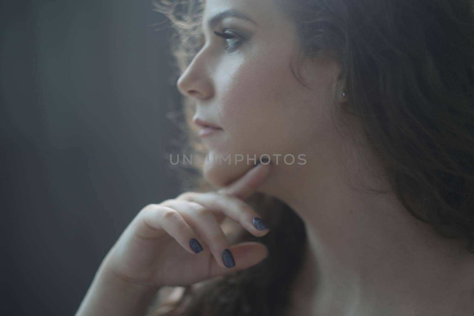 Portrait of a beautiful sensual young woman with curly hair. by paralisart