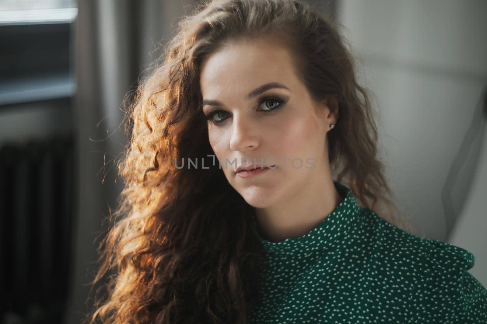 Portrait of a beautiful sensual young woman with curly hair