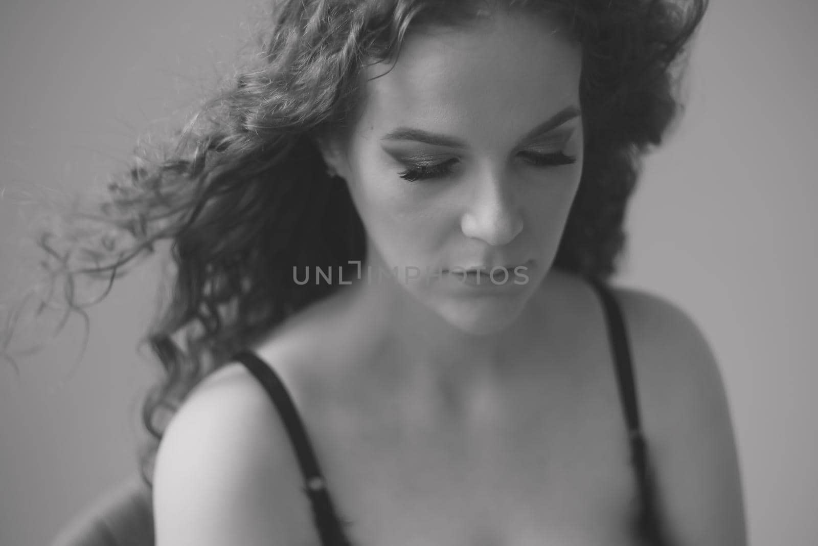 Portrait of a beautiful sensual young woman with curly hair