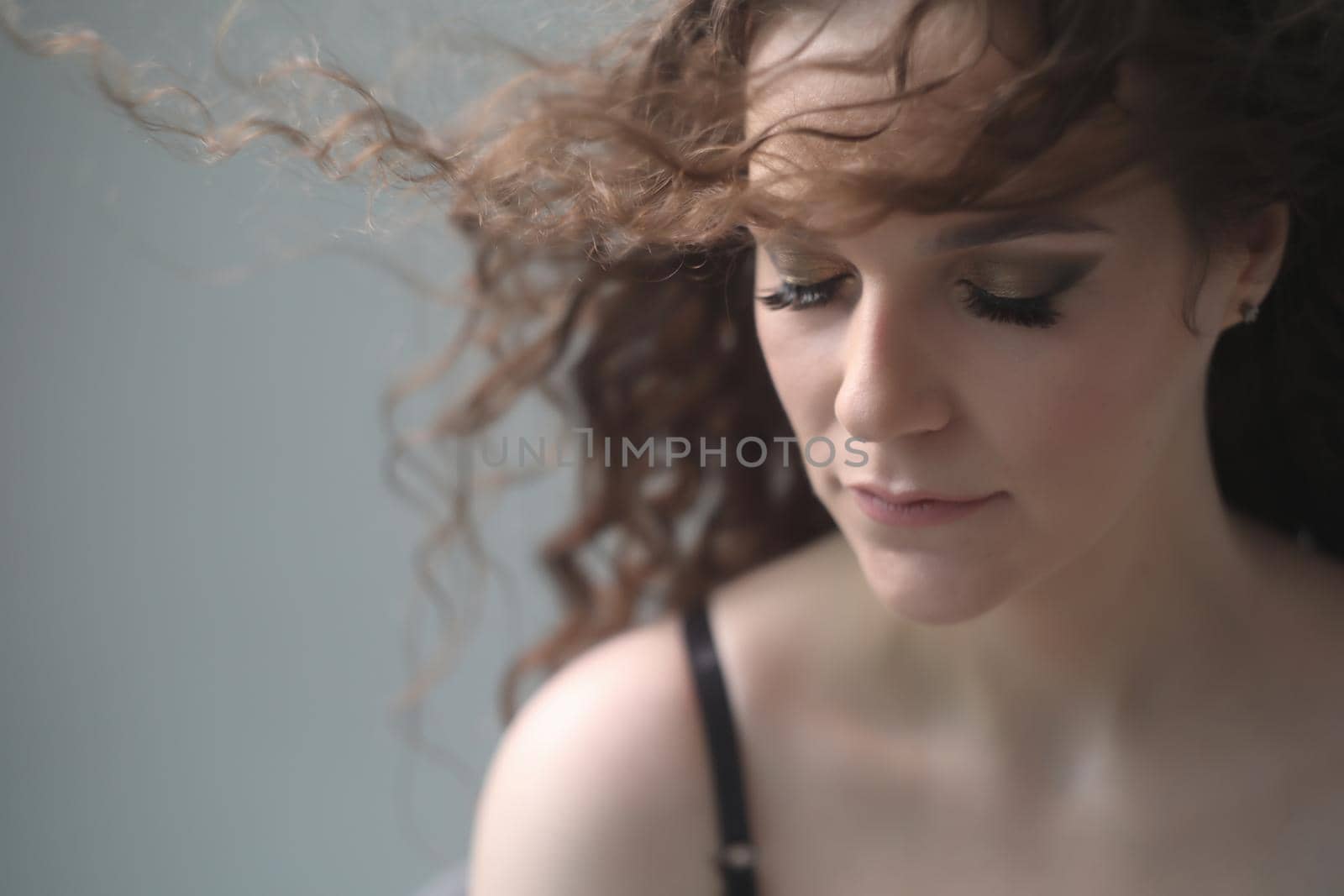 Portrait of a beautiful sensual young woman with curly hair