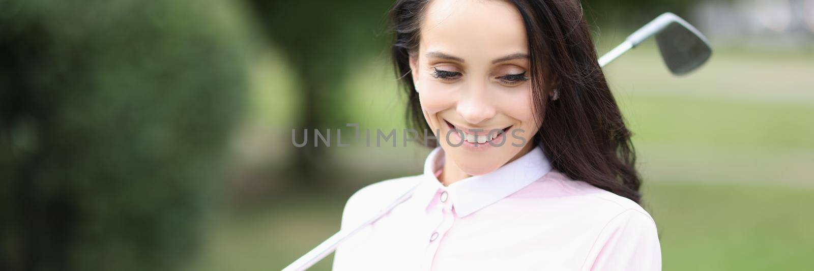 Portrait of smiling professional golf player woman hold ball on palm. Energetic female ready to play active game on field. Golf, sport, champion concept