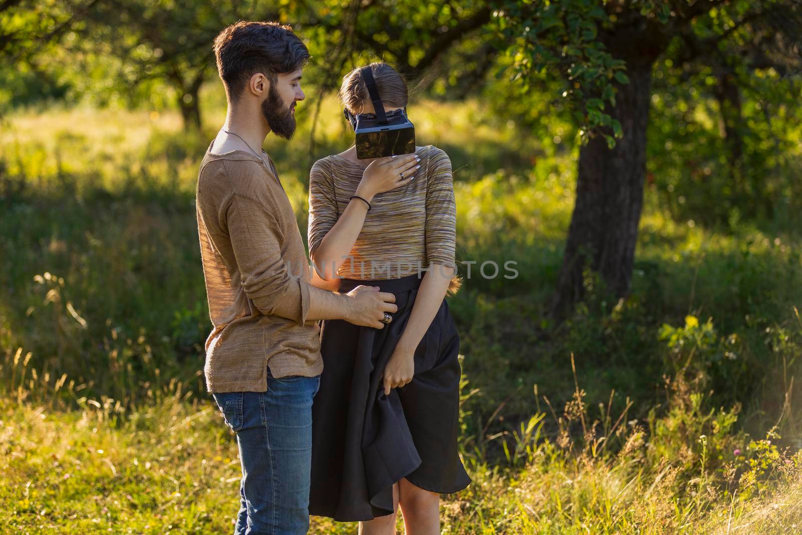 couple in nature, girl in virtual reality glasses close-up