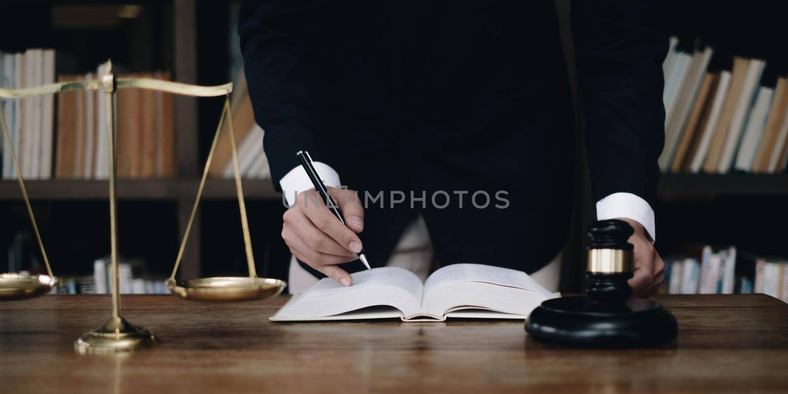 justice and law concept.Male judge in a courtroom on wooden table and Counselor or Male lawyer working in office. Legal law, advice and justice concept..