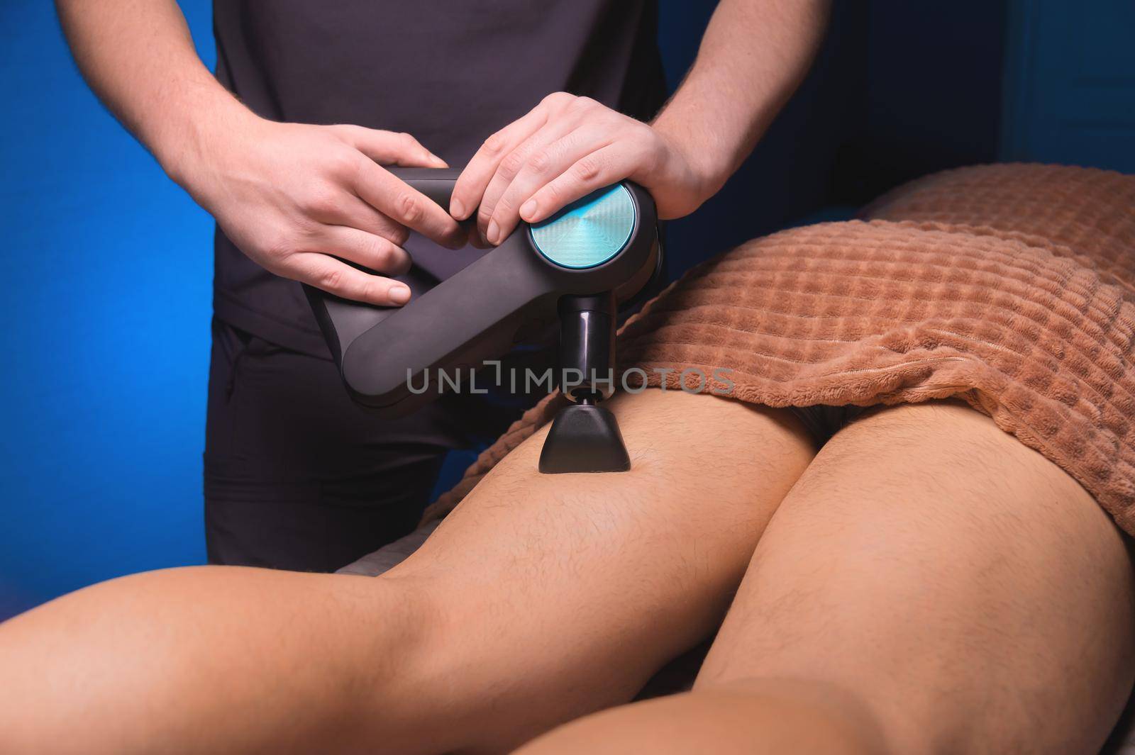 Close-up percussion thigh massage with a special electric device by yanik88