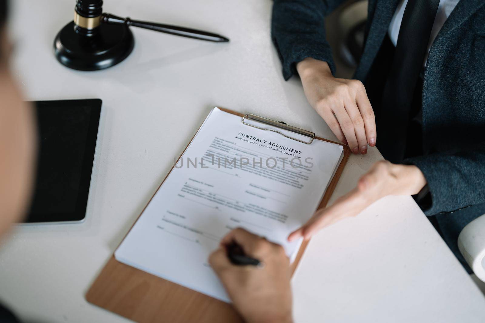 Lawyer Legal counsel presents to the client a signed contract with gavel and legal law. justice and lawyer Business partnership meeting concept