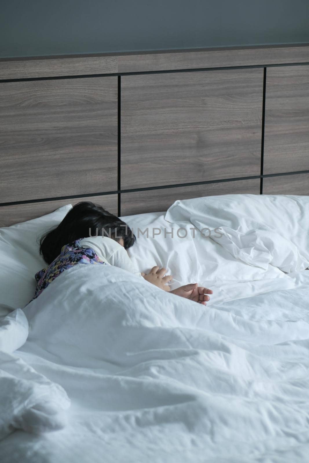 4 year old child girl sleeping on bed .