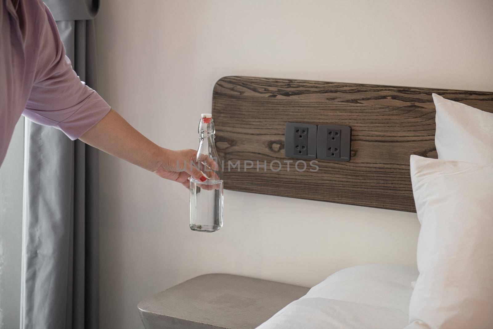 Housekeeper or Maid cleaning hotel room. Asian woman worker working in hotel and resort.