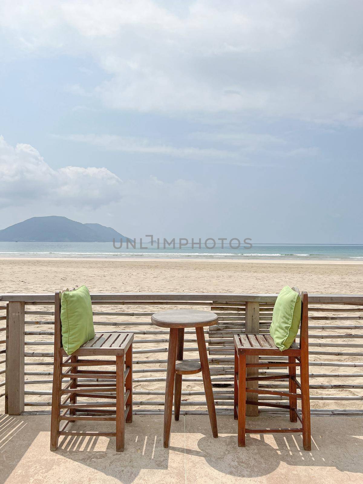Wooden chairs of restaurant overlooking near the sea beach.