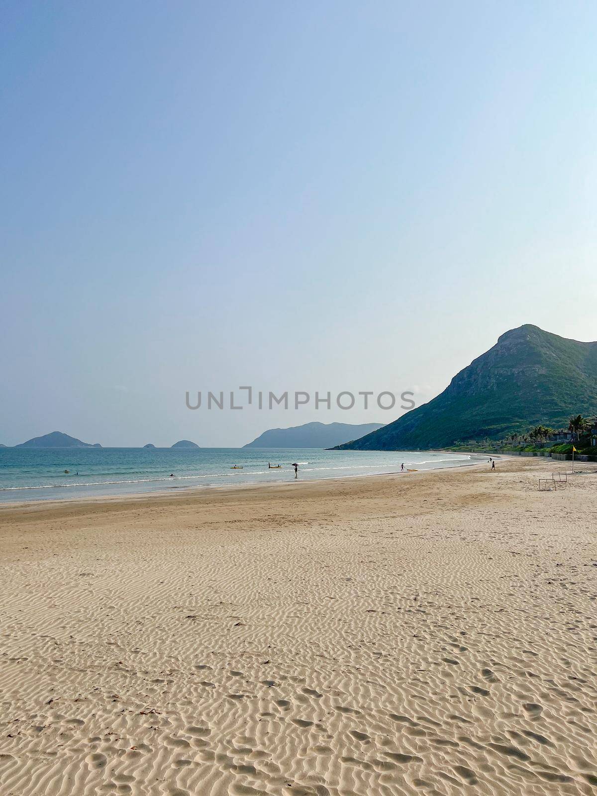 Tropical Sand Beach with lush green Mountains, blue Sky and beautiful Landscape. by makidotvn