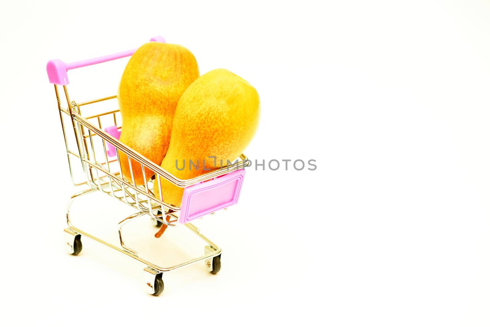 Metal shopping trolley in a supermarket store with two white ripe savory pears by jovani68