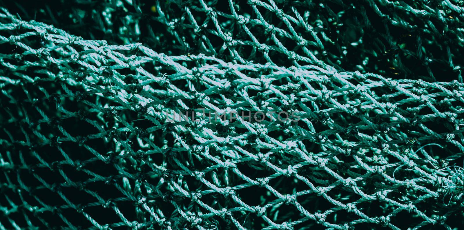 BANNER abstract close-up macro real photo beautiful wallpaper. Fisherman rope net texture fiber surface pattern. Sea blue green light colour. Futuristic subtle waving lines art modern Dark background