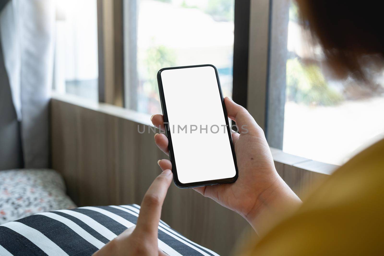 cell phone blank white screen mockup.woman hand holding texting using mobile at cafe. background empty space for advertise.work people contact marketing business,technology