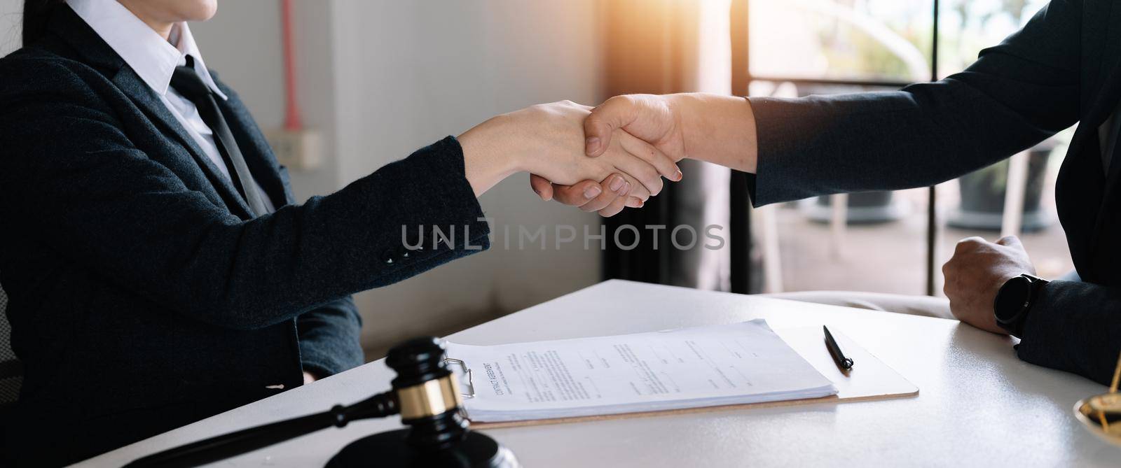 The lawyer handshake with client to congratulate and confirm the agreement in the law firm