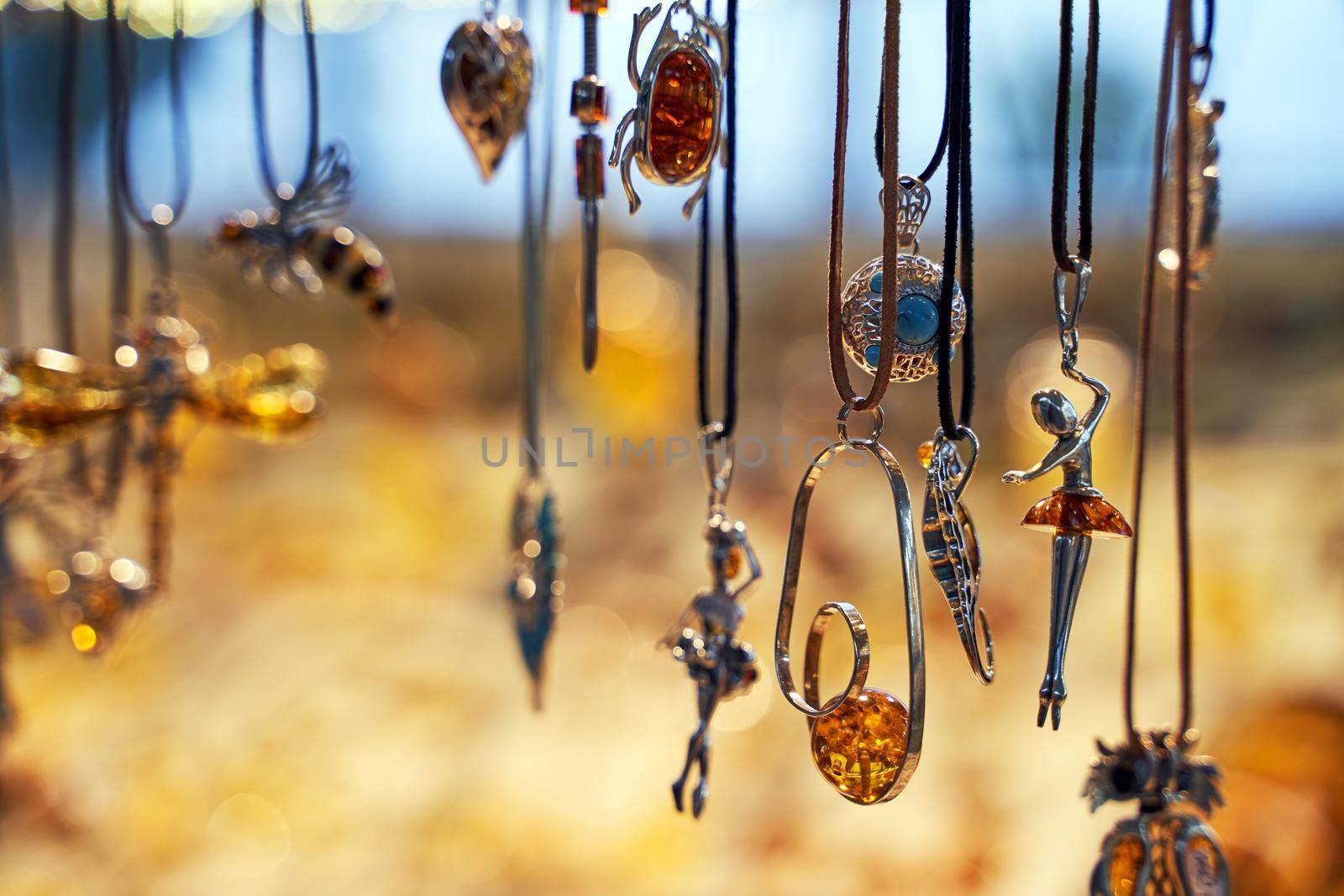 Sopot, Poland, Oct 5, 2018: Amber jewelry pendants displayed on a shopfront in the city center.
