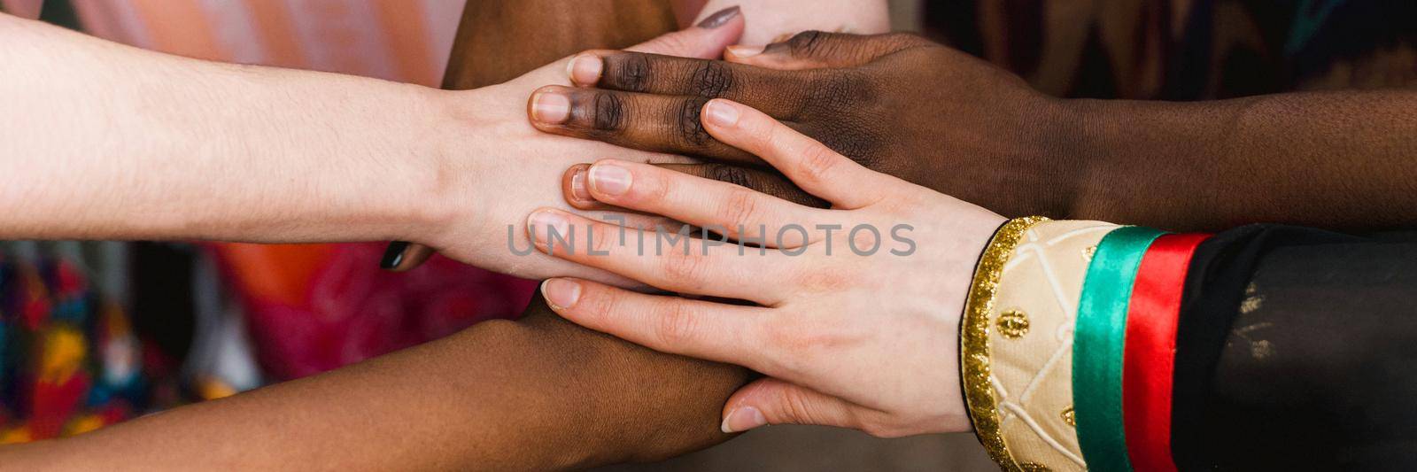 National diversity. People of different appearance and nationality stand in a circle together and hold hands. Team building and partnership business concept. Web banner