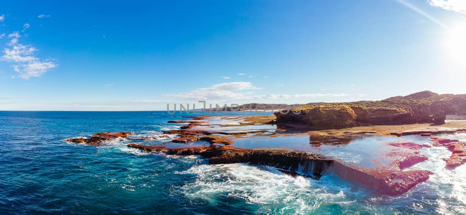 The lesser known Monforts Beach and its rockpool formations on a sunny day in Blairgowrie, Victoria, Australia