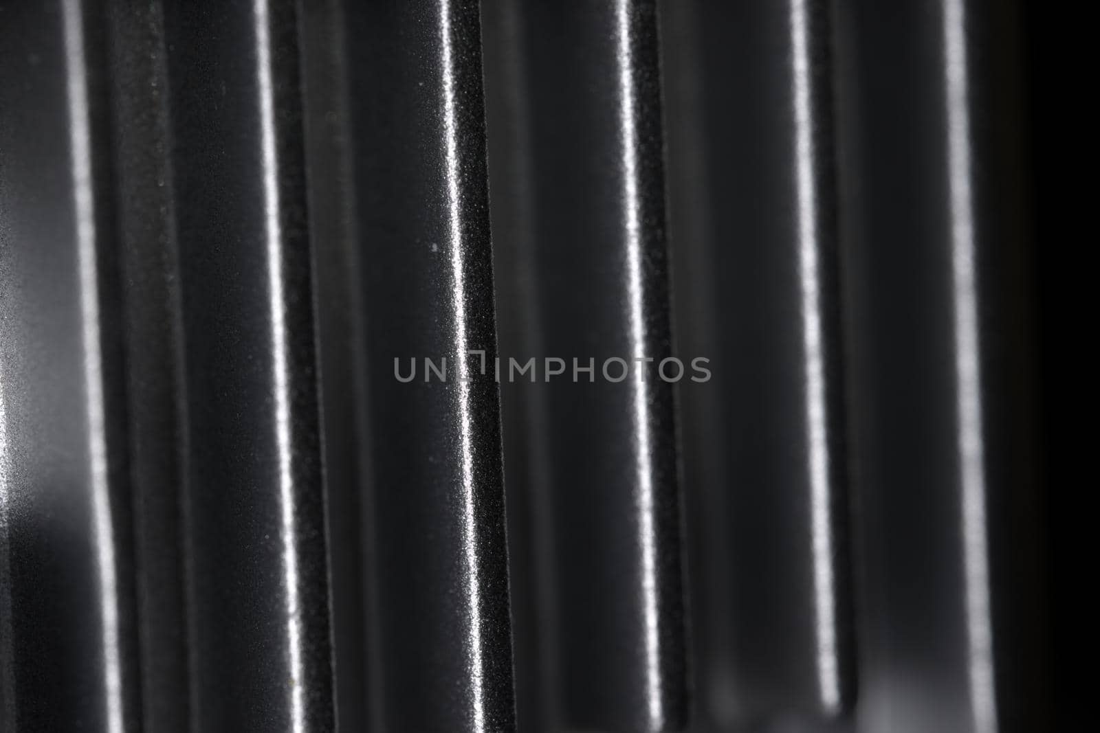 Abstract metal texture detail from the cooling fins of a drone gimbal heat sink. Aluminum or aluminium in material. Full frame abstract background.