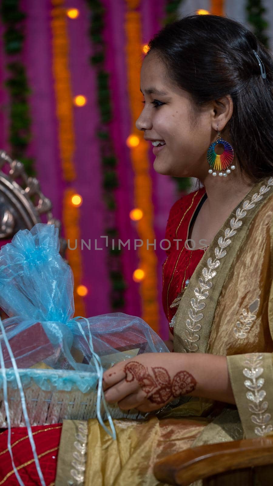 Indian families celebrating Raksha Bandhan festival a festival to celebrate the bond between brother and sister. Rakhi celebration in India. Feeding sweets, applying tikka.