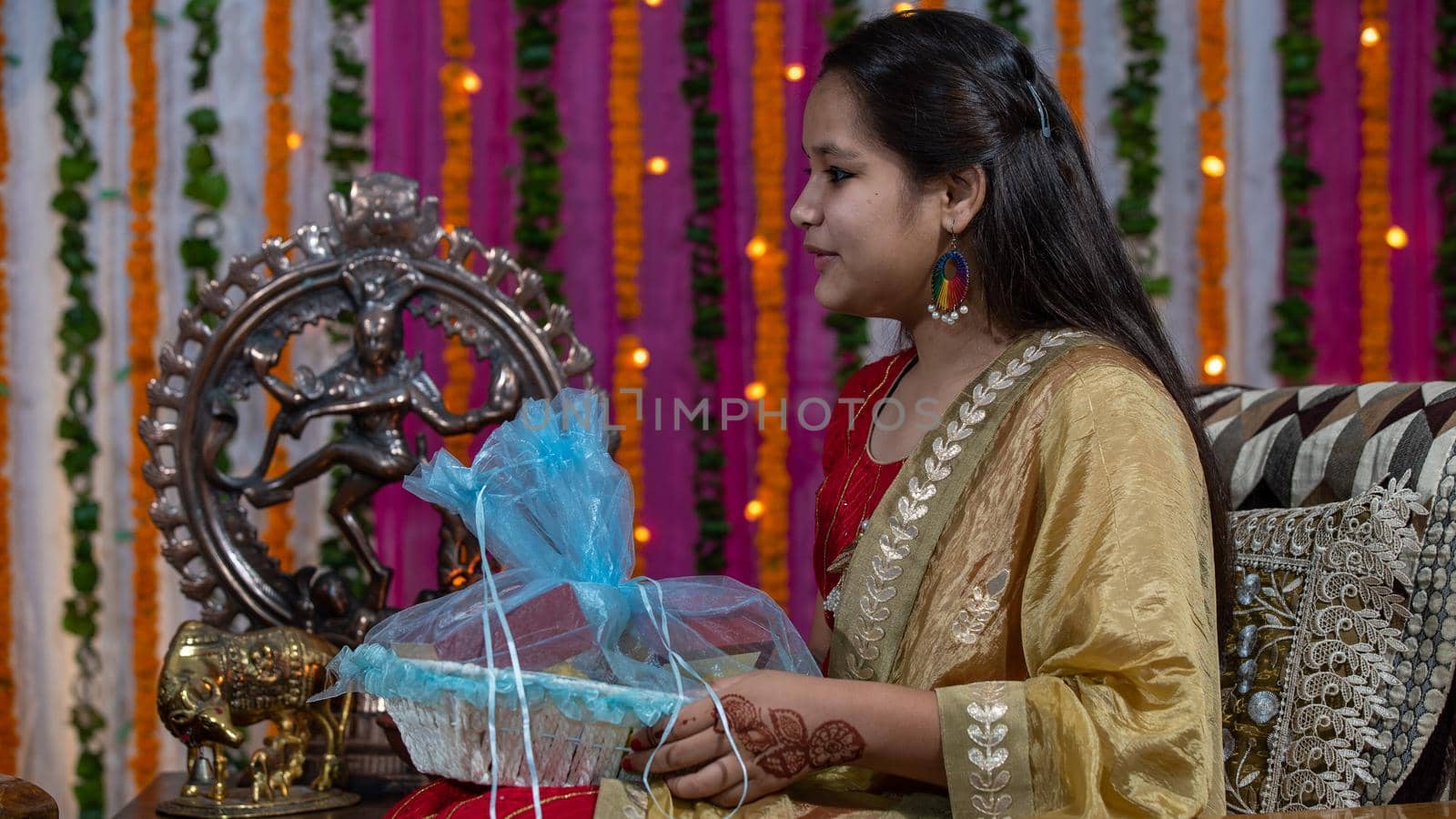 Indian families celebrating Raksha Bandhan festival a festival to celebrate the bond between brother and sister. Rakhi celebration in India. Feeding sweets, applying tikka.